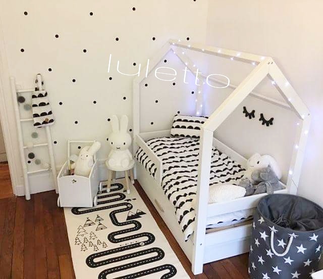 Lit maison noir et blanc dans une chambre de bébé garçon avec décoration minimaliste en noir et blanc.